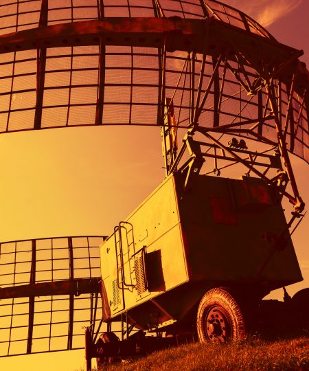 Mobile military radar installation on the background of the sunset orange sky