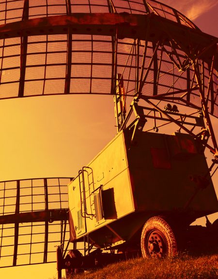 Mobile military radar installation on the background of the sunset orange sky