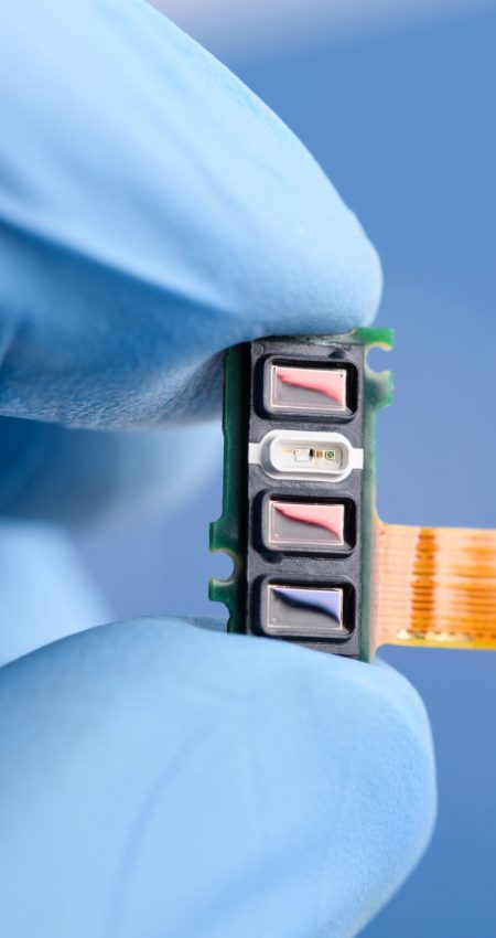 Scientist hold in fingers fitness tracker smart watch component with different sensors array, pulse optical heart rate, skin temperature, blood oxygen saturation SpO2