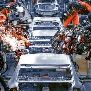In the industrial production workshop, the robot arm of the automobile production line is working In the industrial production workshop, the robot arm of the automobile production line is working